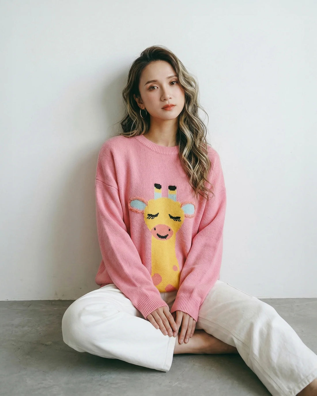 collection banner showing a woman seated on the floor in a pink knit jumper with a giraffe motif, with the heading “Fun & Furry” and collection text below.