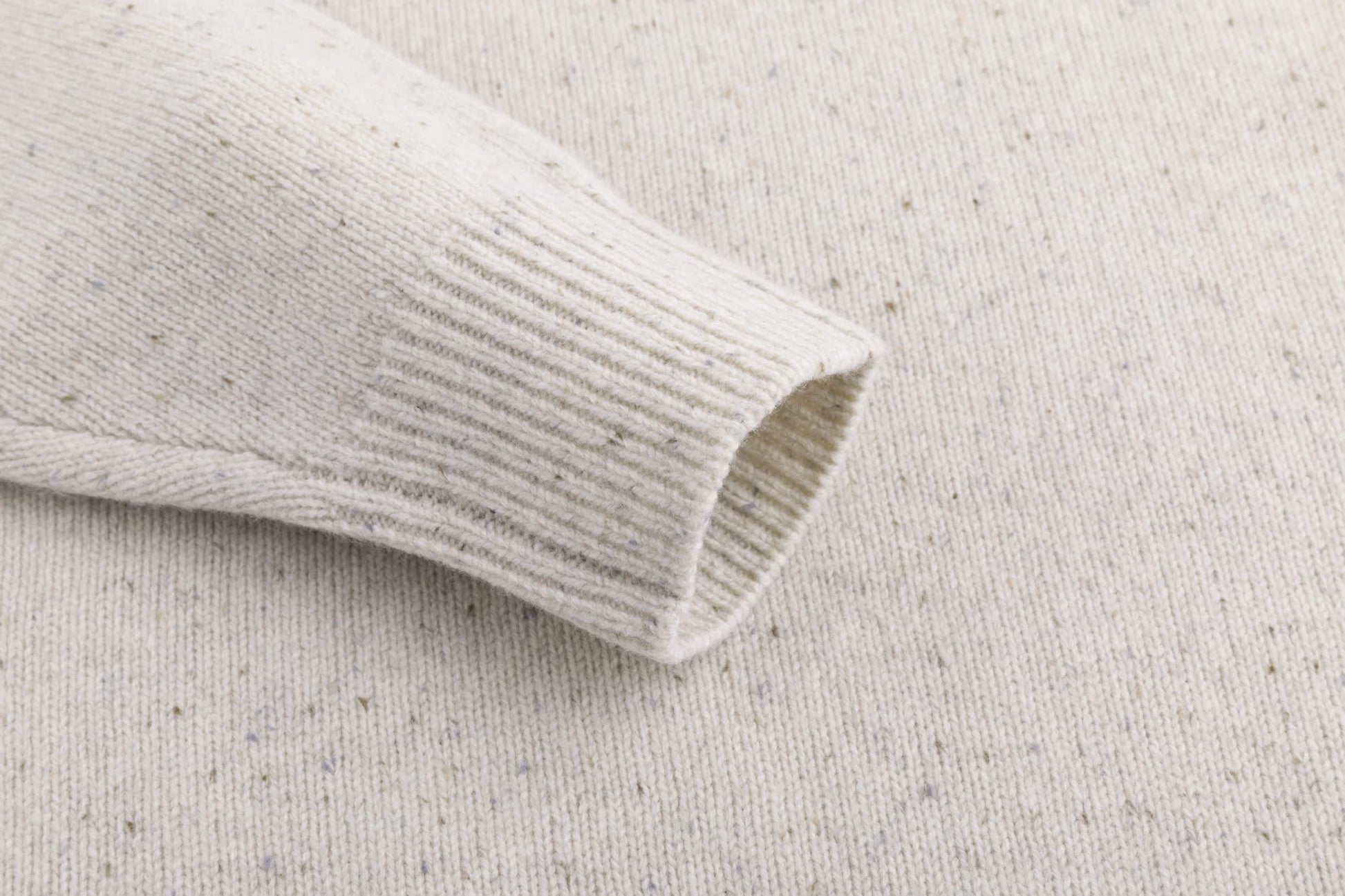 Close-up of the ribbed cuff on the oatmeal jumper.
