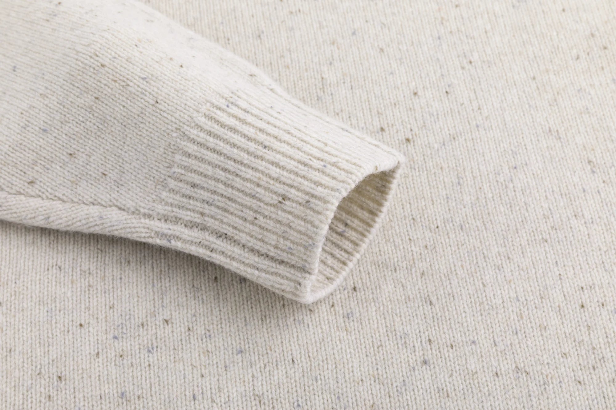 Close-up of the ribbed cuff on the oatmeal jumper.