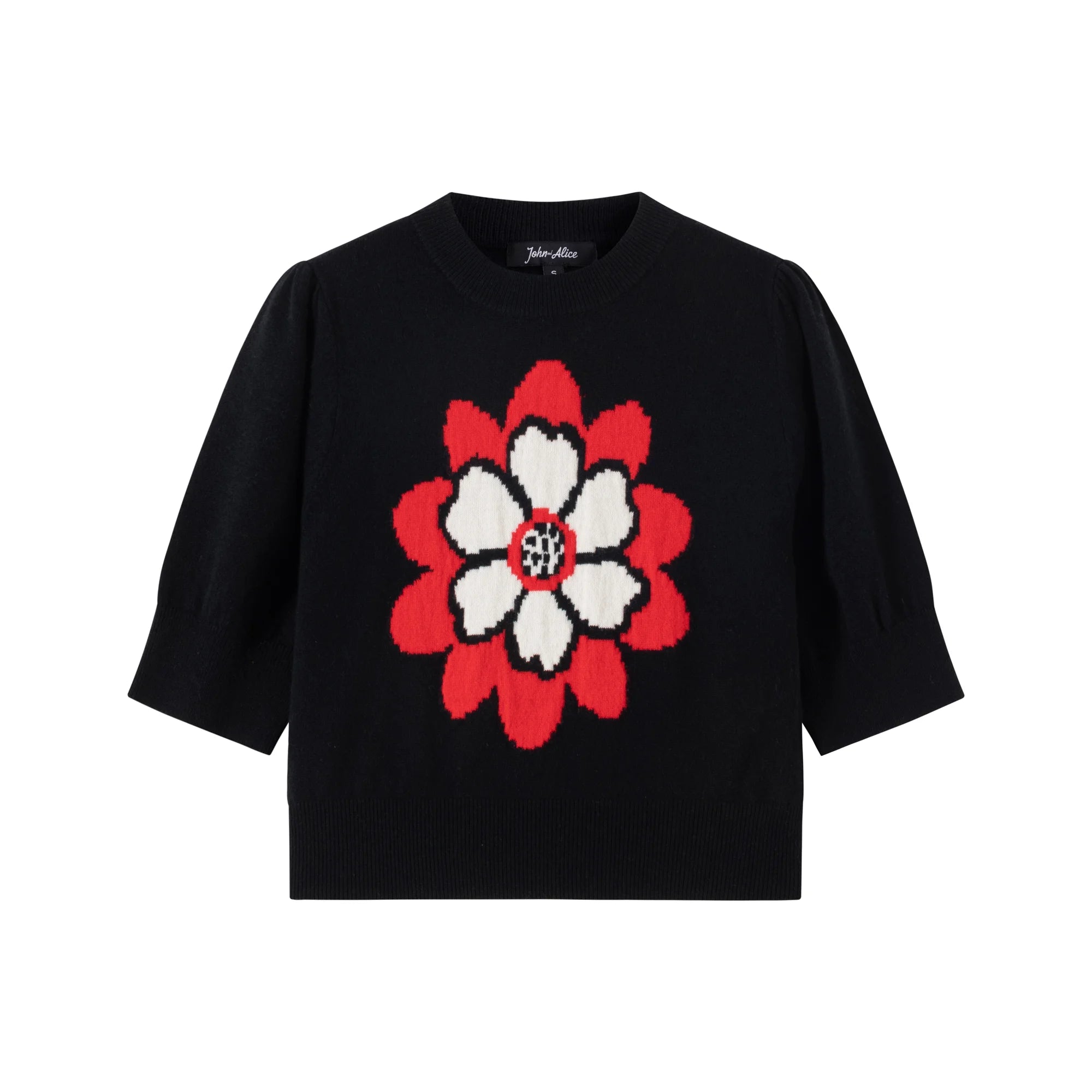 Front view of a black short-sleeve knit top with a crew neck, ribbed hem and abstract flower jacquard on the front.