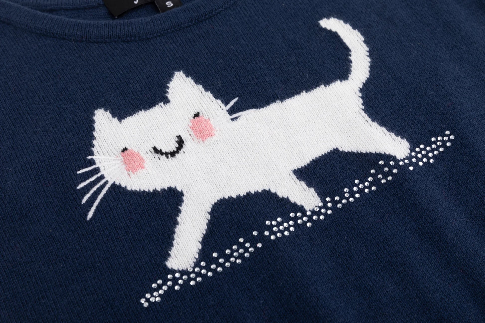 Close-up of the white cat motif and rhinestone accents on the navy knit tank.