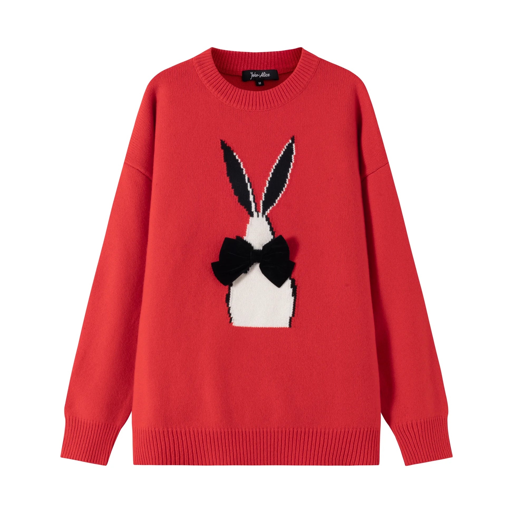Front flat view of a red cotton and wool blend jumper with an abstract rabbit jacquard and a black velvet bow on the front.