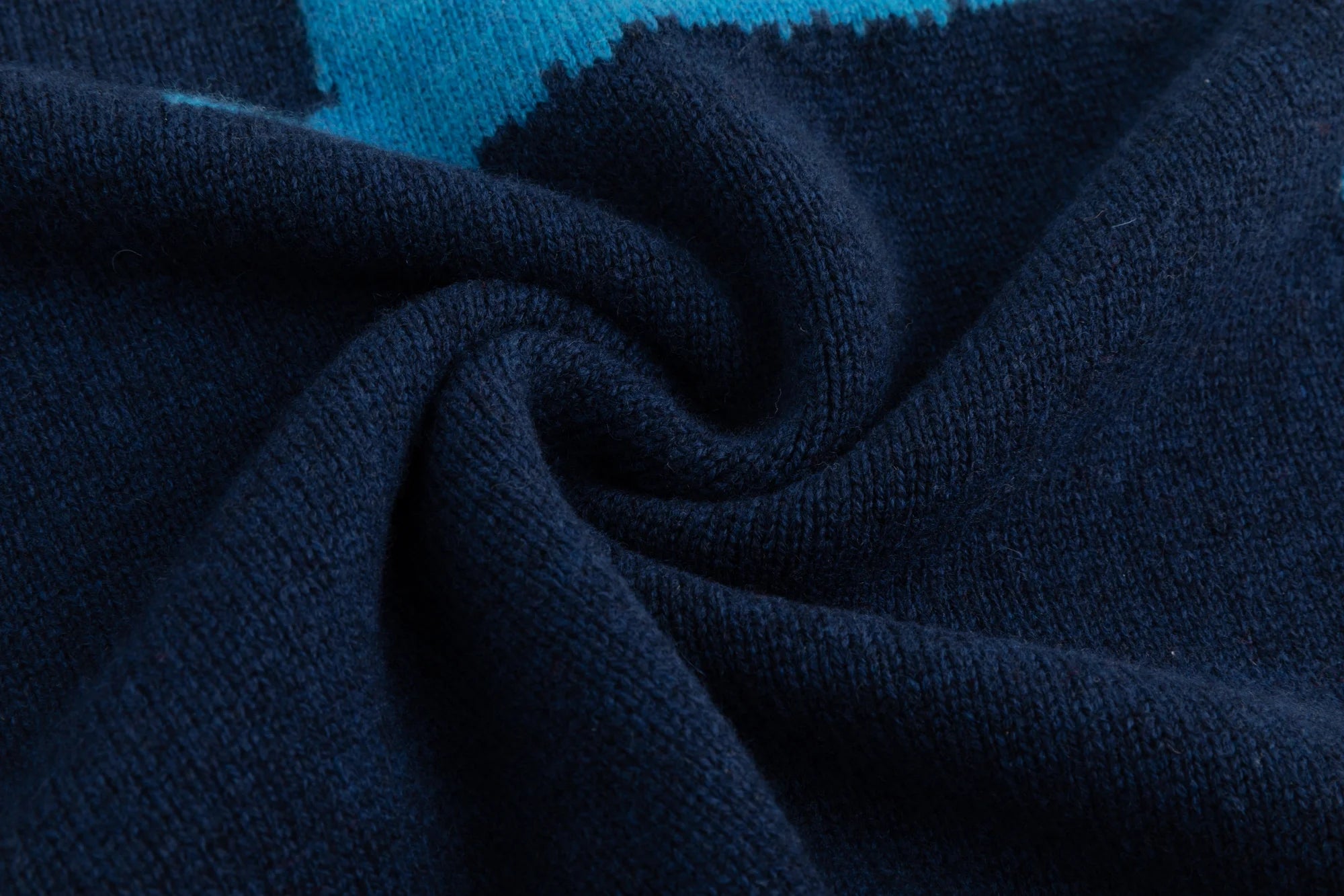 Close-up of the knit texture on a navy jumper.
