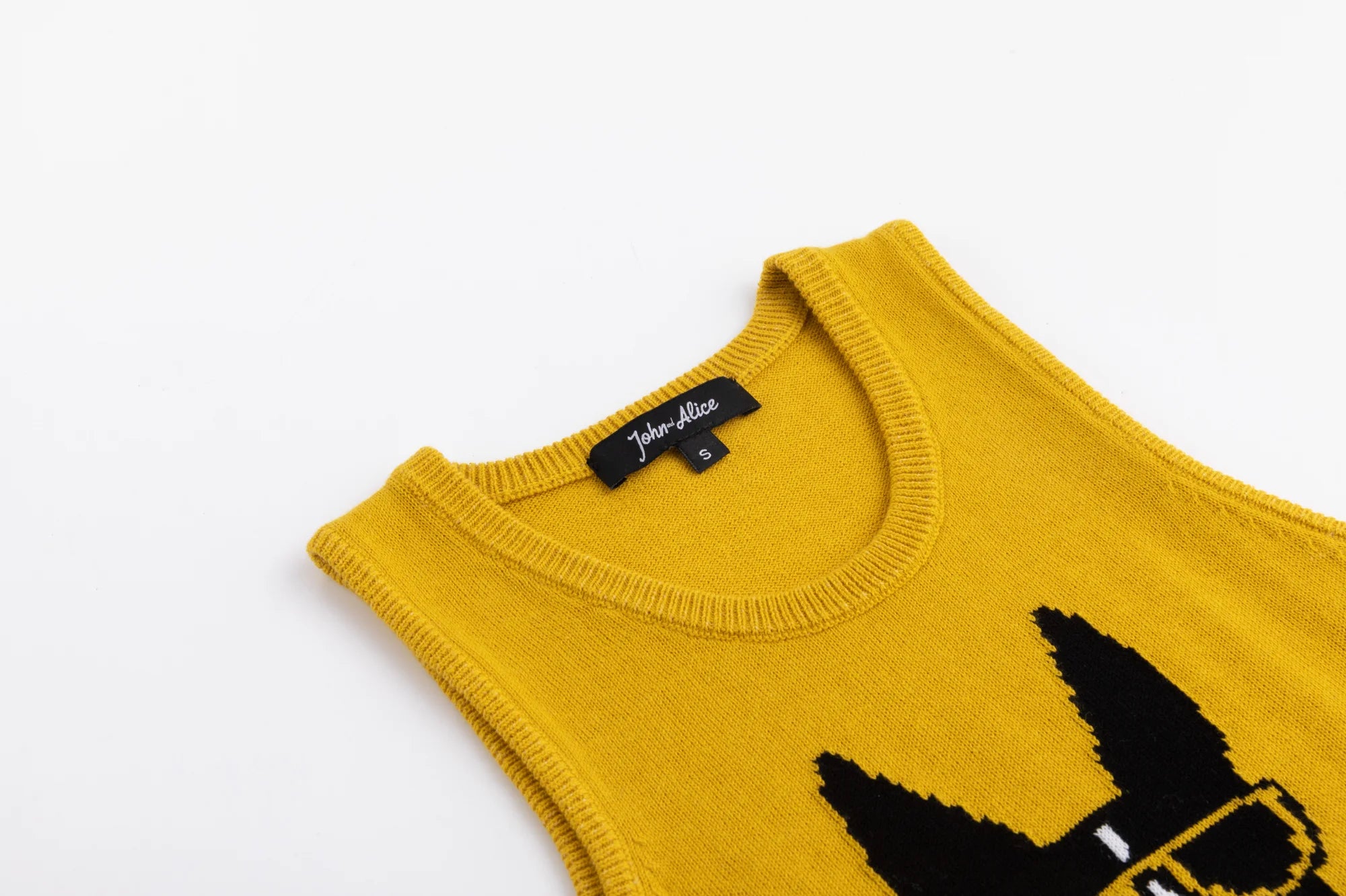 Close-up of the neckline on the mustard yellow cotton knit tank.