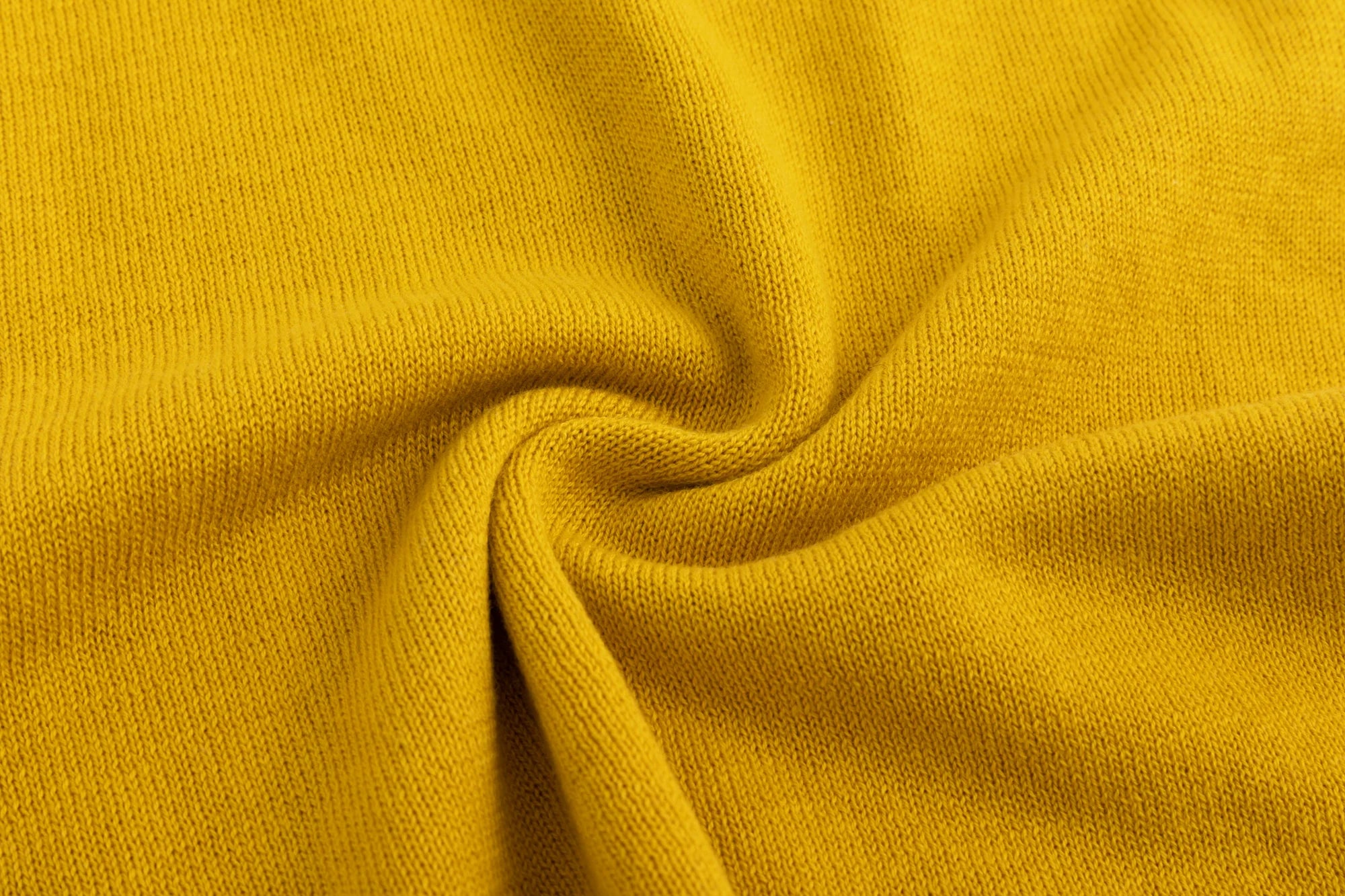 Close-up of the cotton knit texture on the mustard yellow tank.