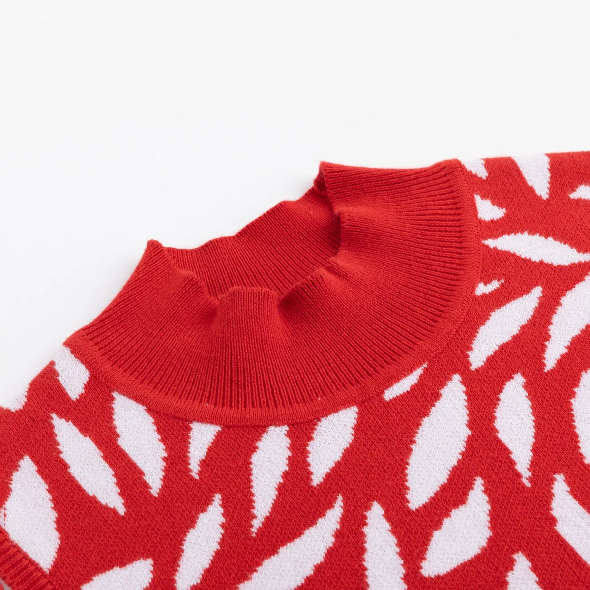 Close-up of the ribbed mock neckline and white foliage jacquard.
