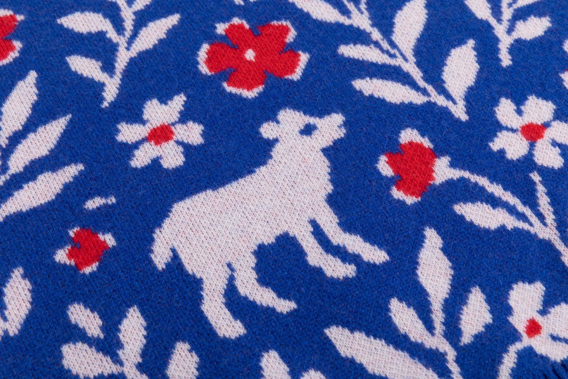 Close-up of the sheep and floral jacquard on the cobalt blue jumper.