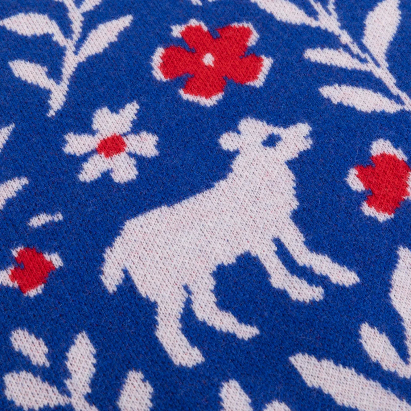 White goat and red flower pattern on the blue Floral Flock knitted jumper