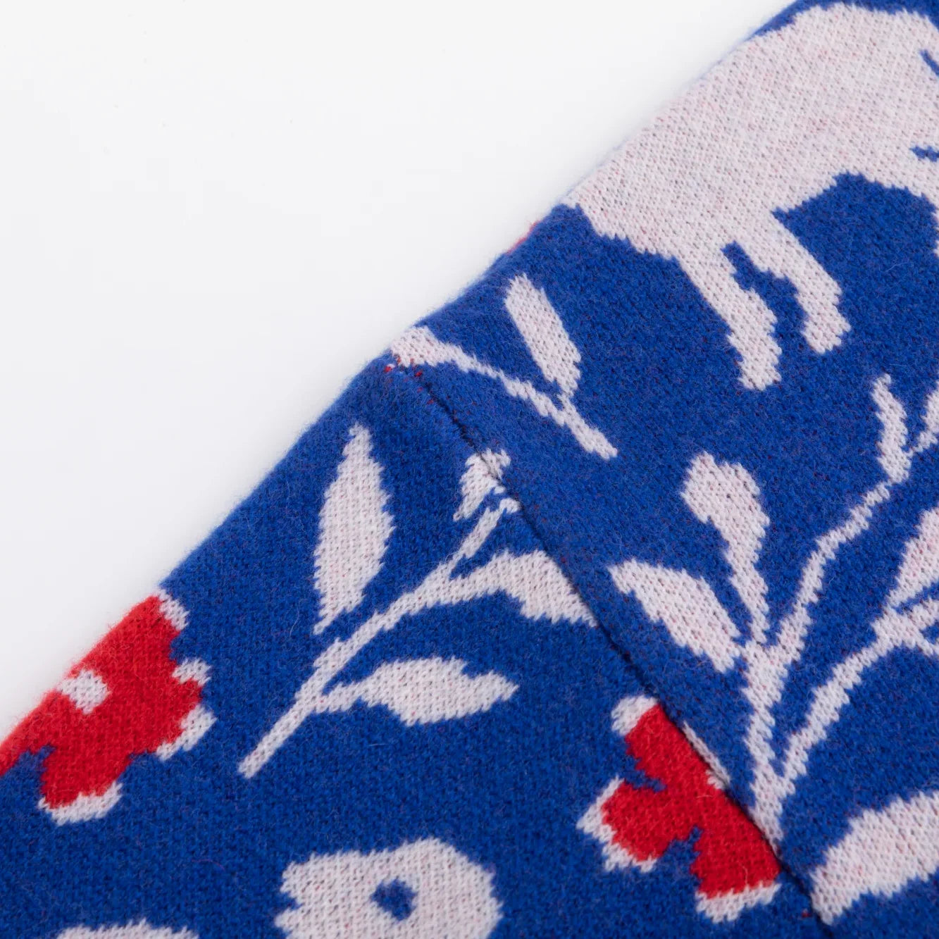 Shoulder detail of the blue Floral Flock jumper with white leaf motifs