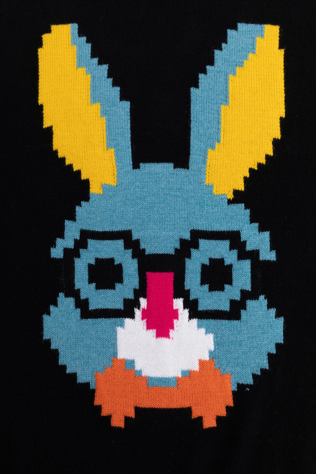 Close-up of the pixel-style rabbit face motif with glasses on the black jumper.
