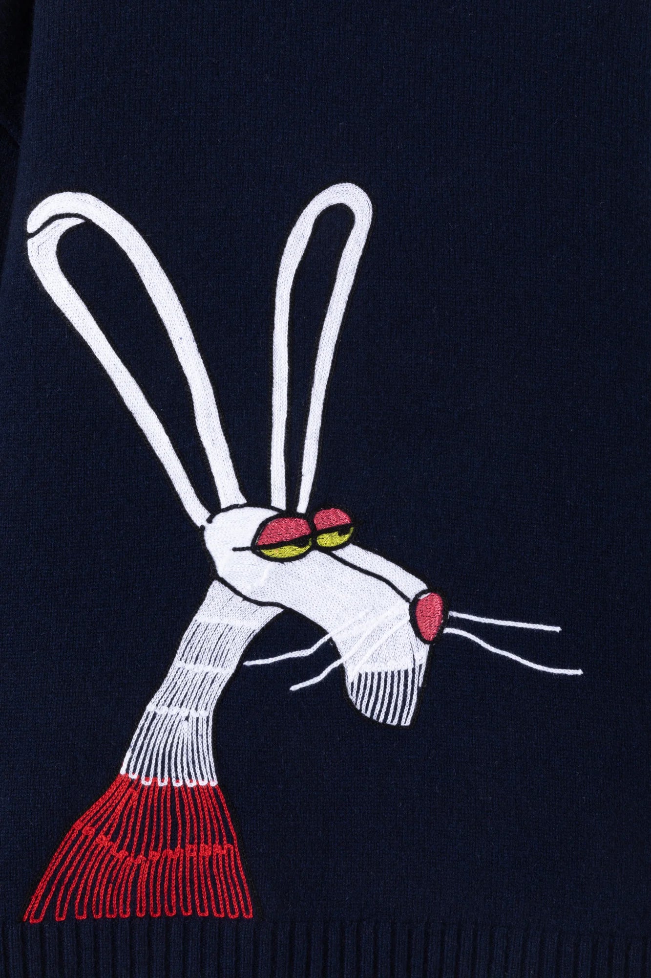 Close-up of the artistic rabbit embroidery on the navy wool jumper.