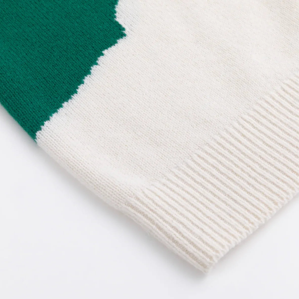 Ivory ribbed hem beside a green knitted colour block
