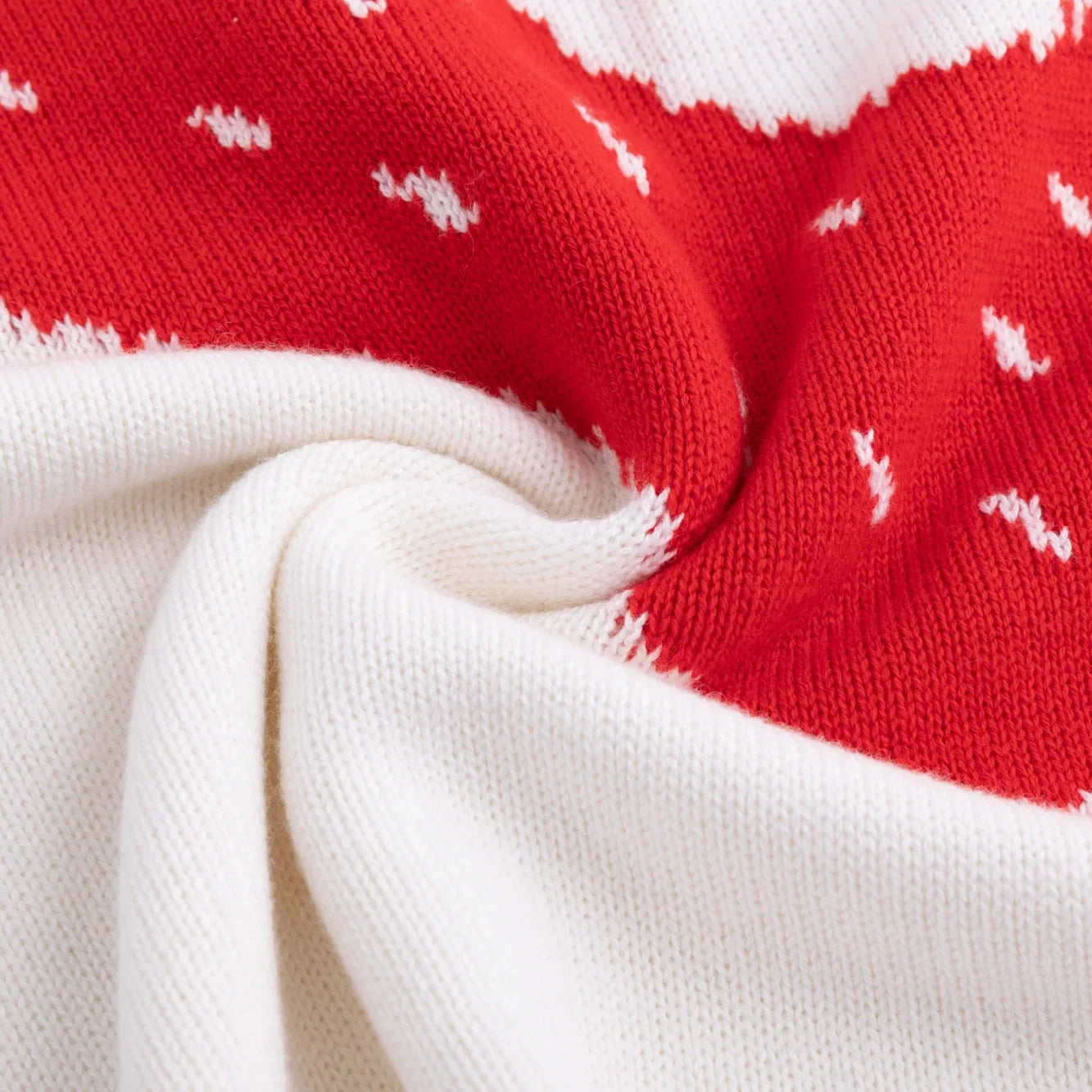 Red knitted ghost motif with black and white eyes on an ivory background