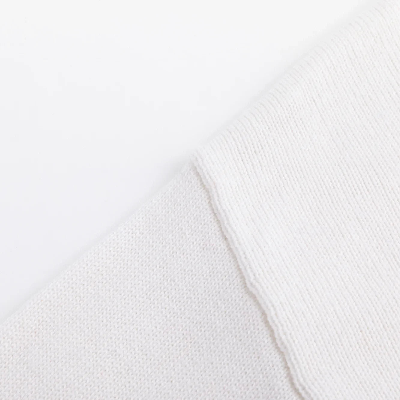 Close-up of the shoulder seam on the ivory knitted jumper