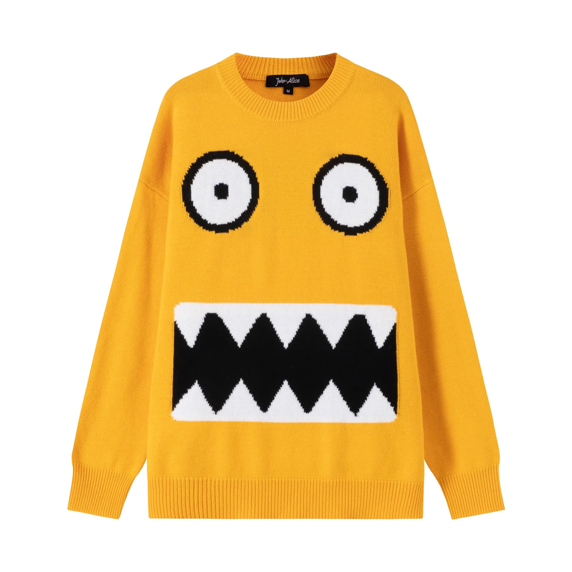 Front flat view of a mustard yellow cotton and wool blend jumper with a monster face jacquard on the front.