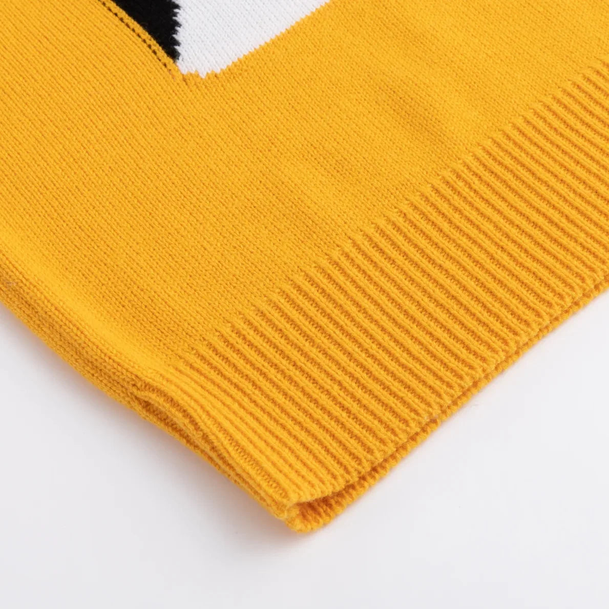 Mustard yellow ribbed hem below the black and white pattern