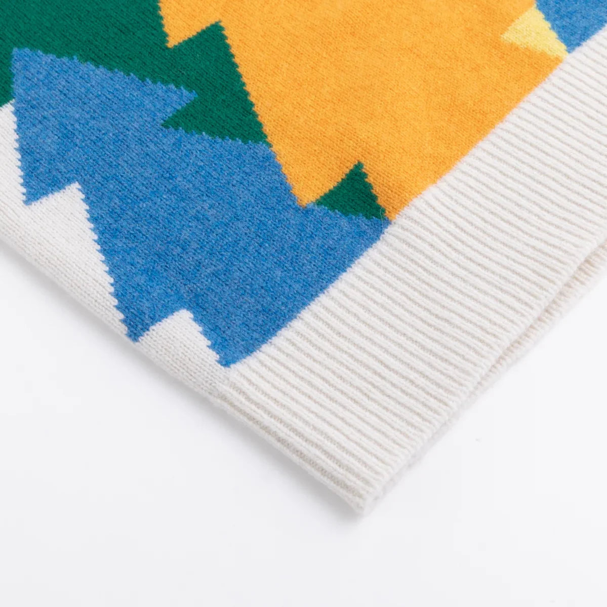 Ivory ribbed hem with blue, green and orange tree motifs