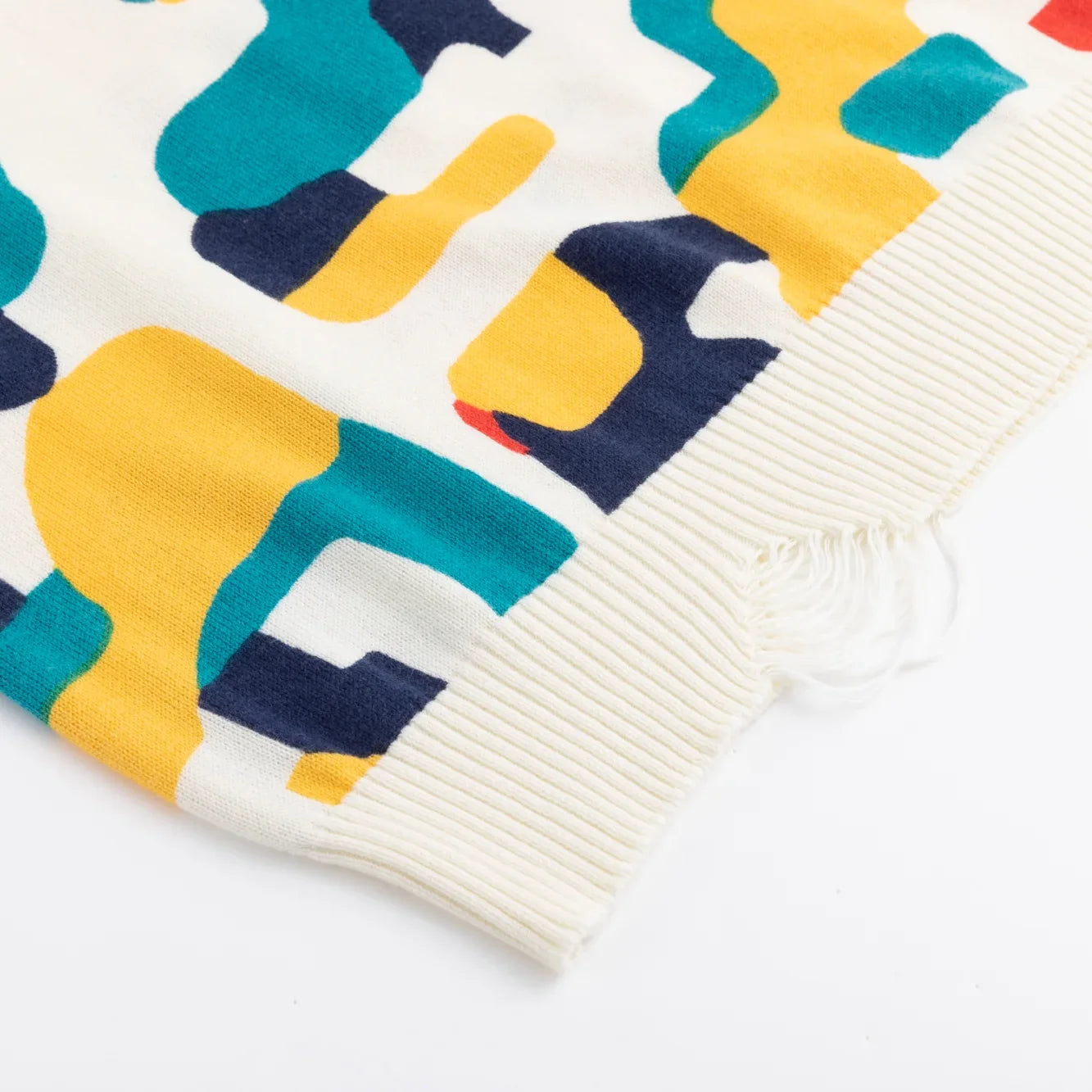 Close-up of the distressed ribbed hem on the ivory multicolour jumper.