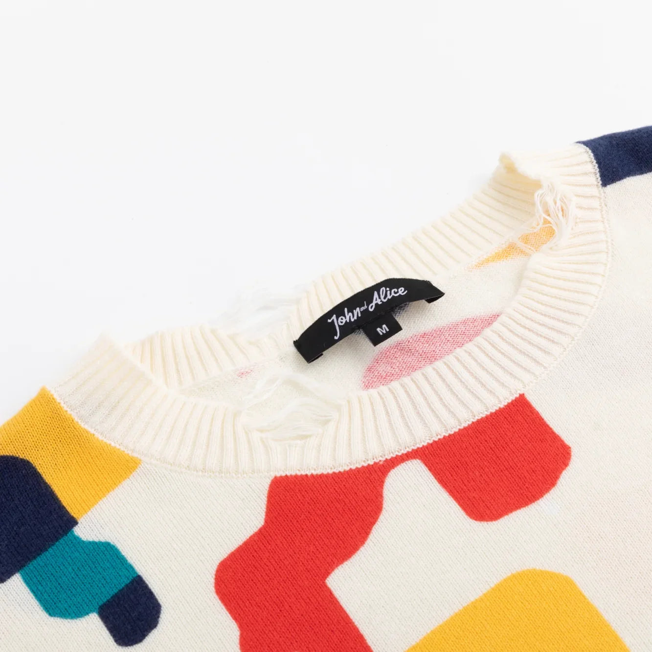 Close-up of the ribbed neckline on the ivory multicolour horse-print jumper.