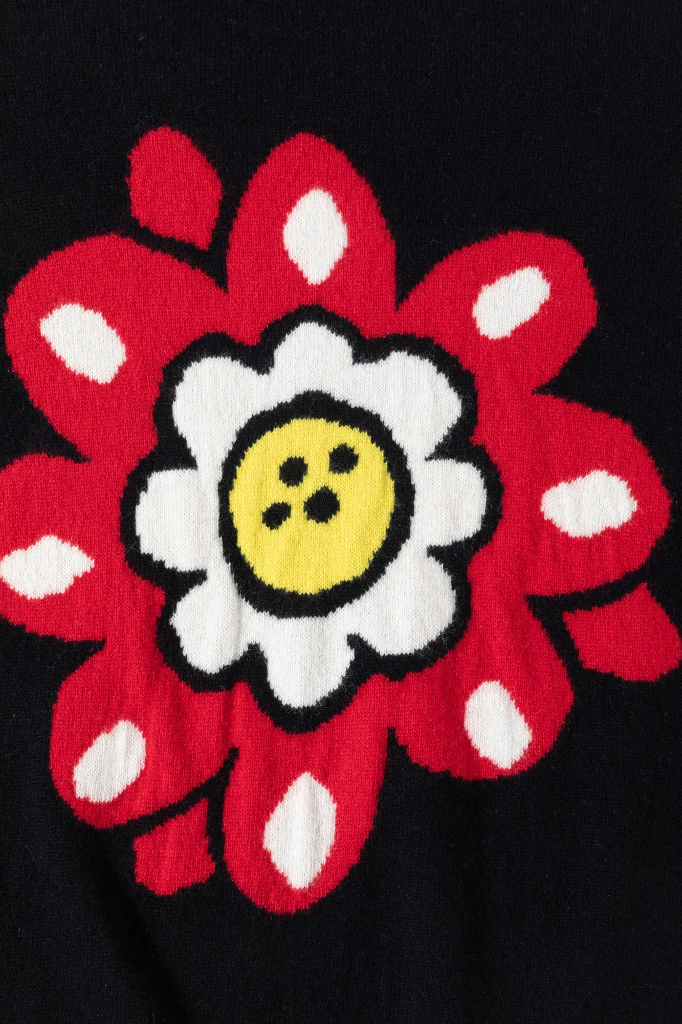 Close-up of the floral intarsia on the back of the black cardigan.
