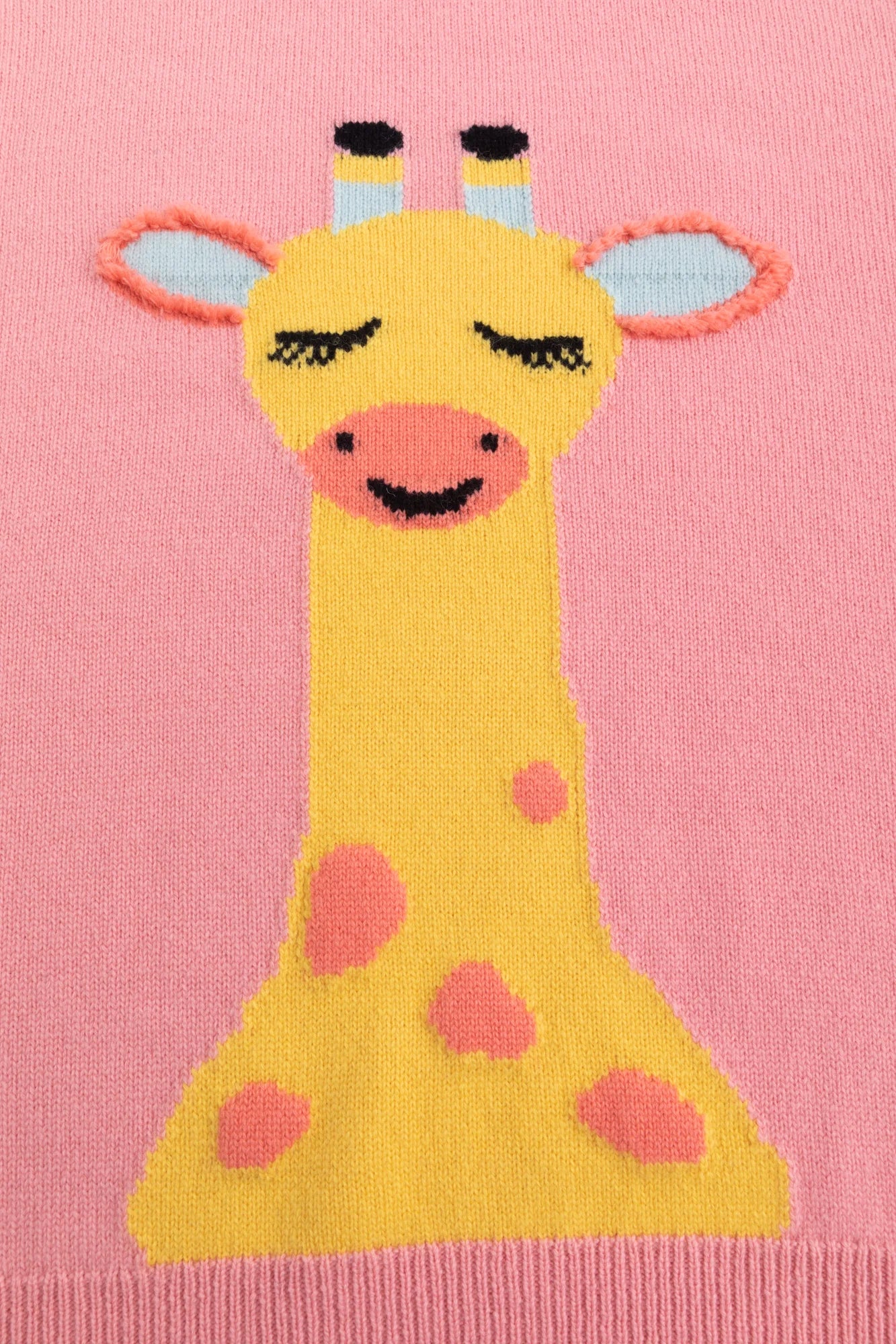 Close-up of the giraffe intarsia with hand-crocheted fringe trim on the ears.